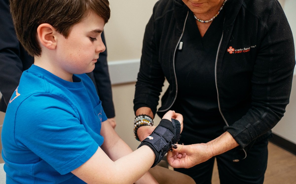 Medical provider fitting child for a wrist splint